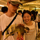 A female tourist touching the squirrel monkey in chain.